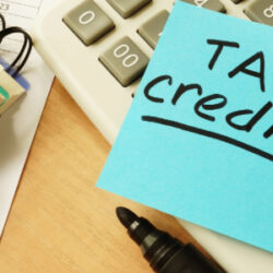 photo of calculator and note - reminder about tax credits